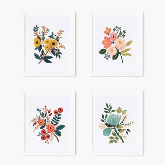 Set of four framed floral art prints with assorted bouquet designs.
