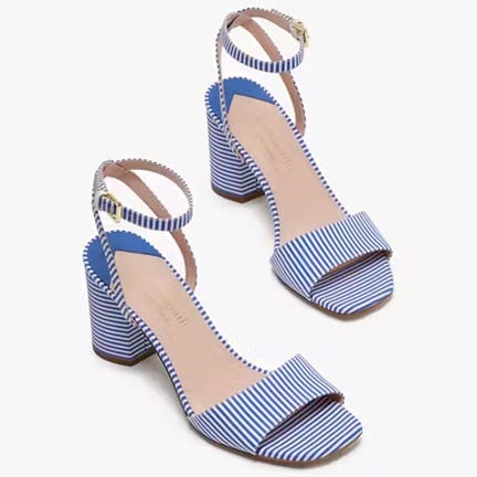 A pair of blue and white striped high-heeled sandals with ankle straps.