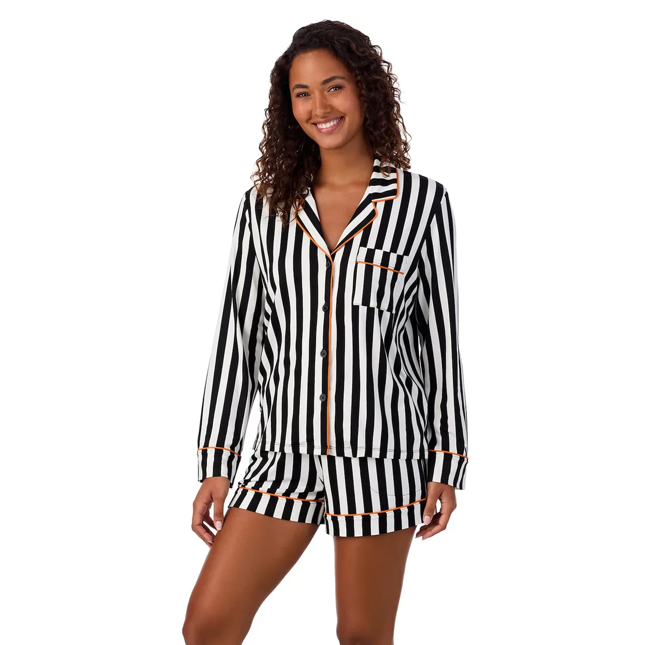 A black and white striped pajama set with orange accents, consisting of a long-sleeve button-up top and matching shorts.