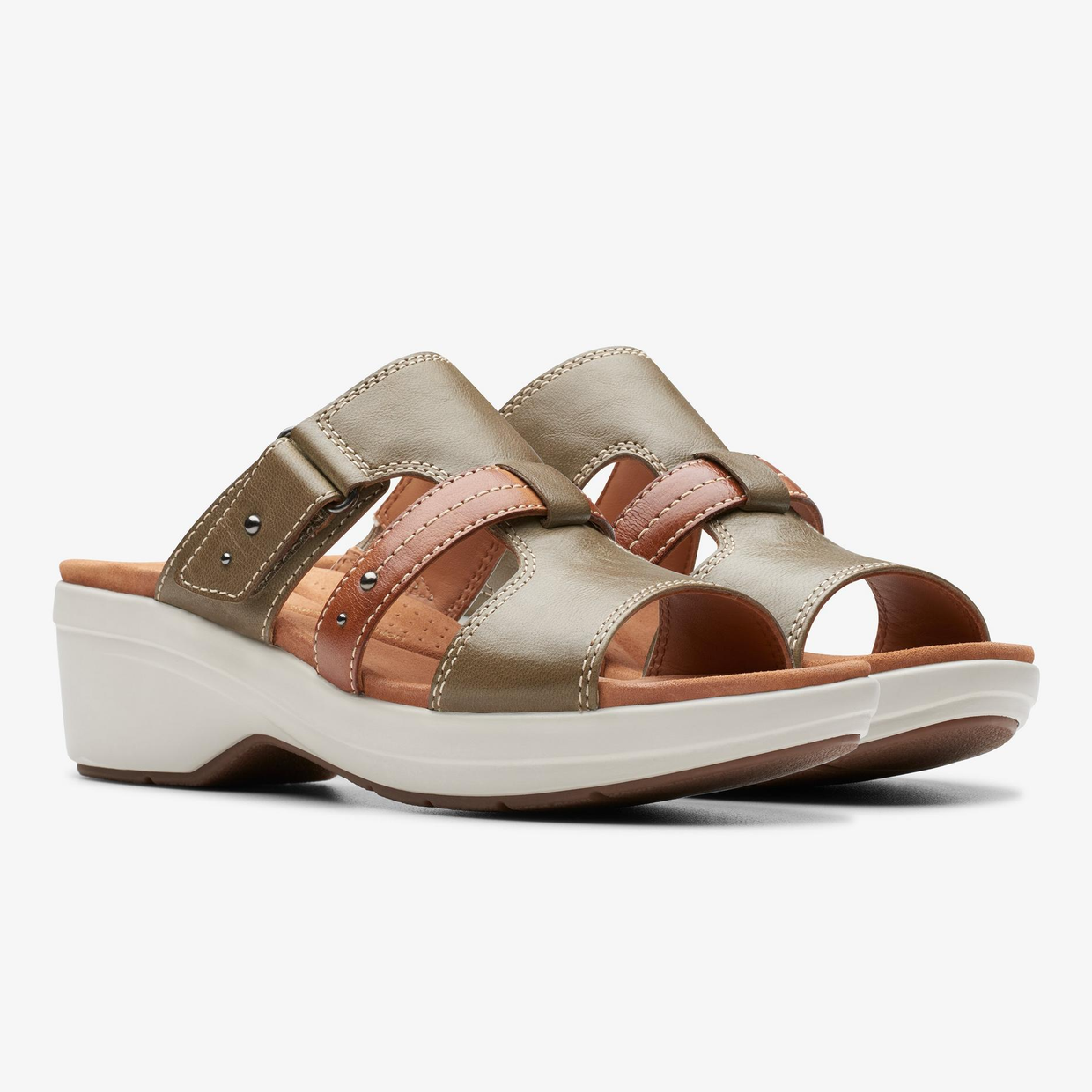 A pair of women's open-toed sandals with a chunky, two-tone sole and metallic and neutral straps.