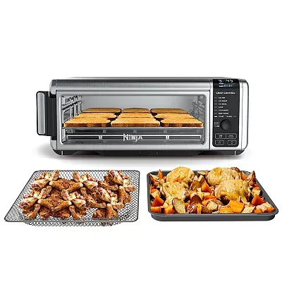 Ninja Foodi Air Fry Oven with a digital control panel, showcasing its ability to cook various foods like chicken, veggies, and toast on wire racks.