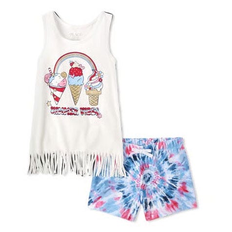 The Americana Summer 2-Piece Outfit Set includes a sleeveless white fringe top with ice cream graphics and \“Summer Vibes\“ text, paired with blue and red tie-dye shorts.