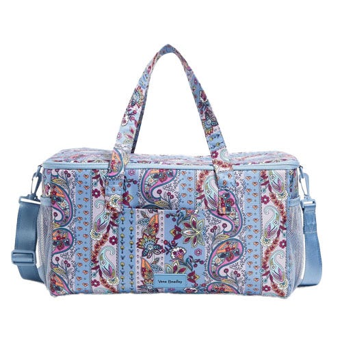 Paisley-patterned duffel bag with blue handles and an adjustable shoulder strap, featuring multiple exterior pockets for storage.