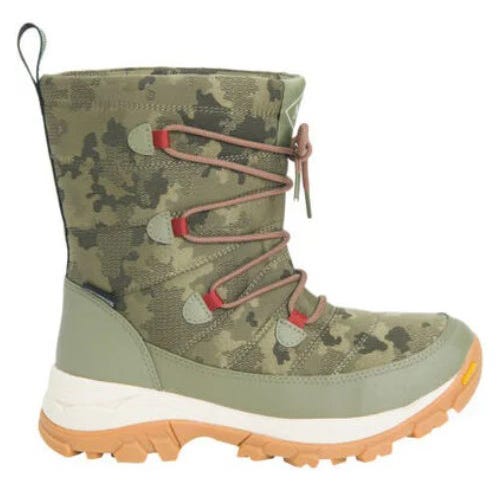 Muck Women's Nomadic Sport Agat Boots feature a camouflage pattern with green and brown shades, red accents on the lace loops, and a rugged tan sole for traction. The boots have a mid-calf height and a pull tab on the back for easy wear.