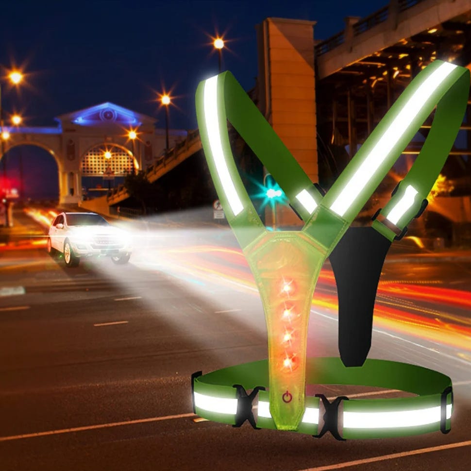Reflective safety harness with LED lights for nighttime visibility.
