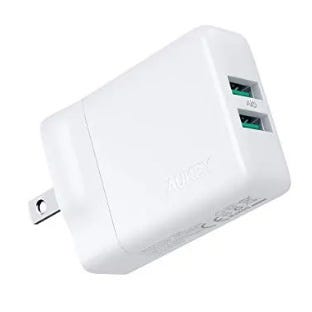 A white dual USB wall charger with a compact design and two charging ports. The brand AUKEY is visible on the side.