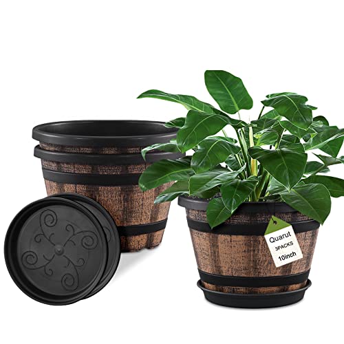 Three faux whiskey barrel planters with a black and brown wood-look finish, each accompanied by a matching saucer, are shown; one planter displays a green plant.