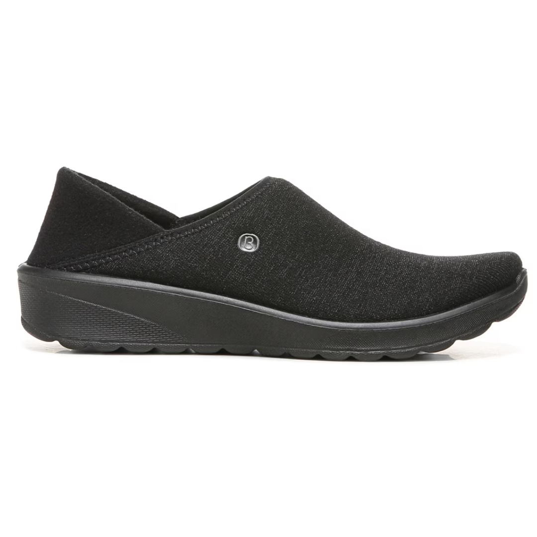A single black slip-on shoe with a low heel and fabric upper.