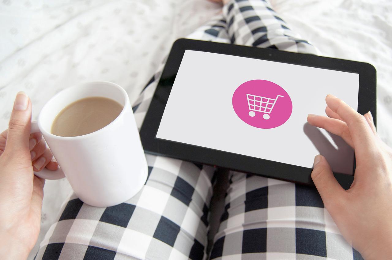 Shopping on a tablet with a cup of coffee