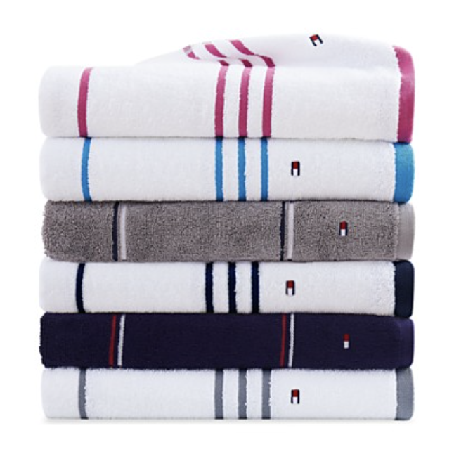 A stack of folded towels with various stripe patterns and colors.