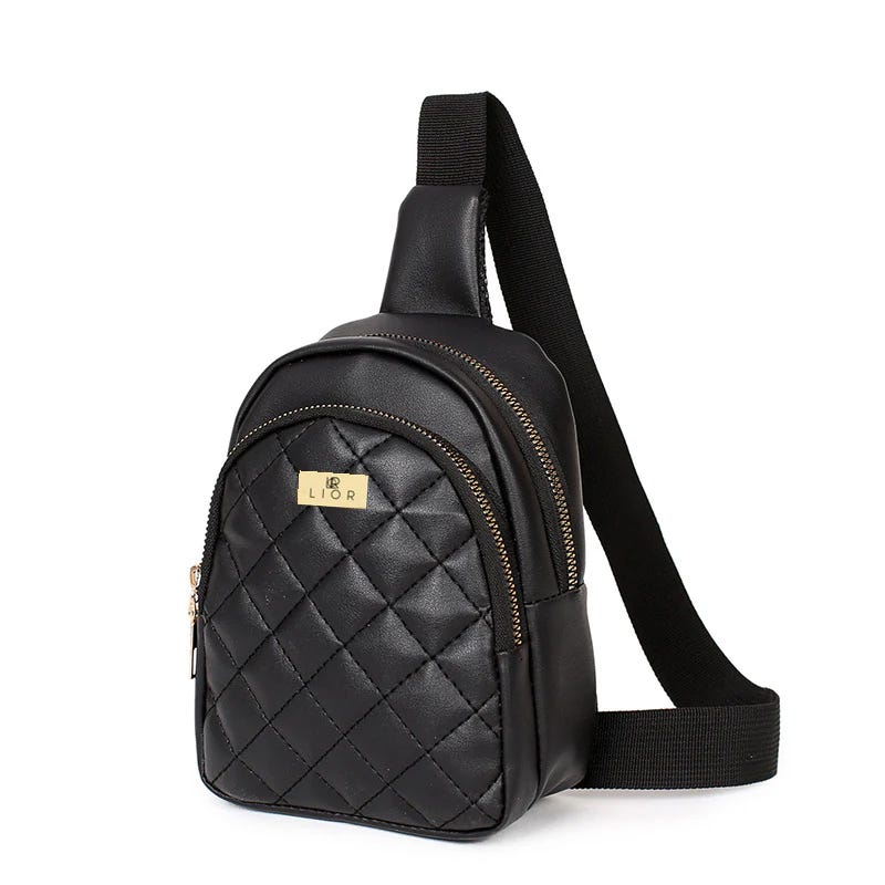 A black, quilted sling backpack with gold-colored zipper detailing.