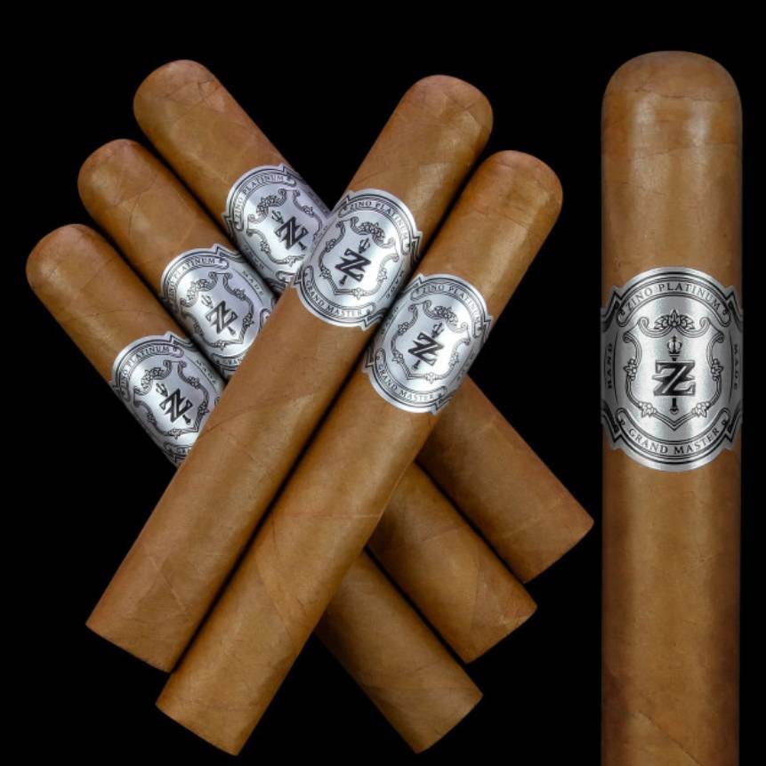 A set of cigars with silver and black bands against a black background.