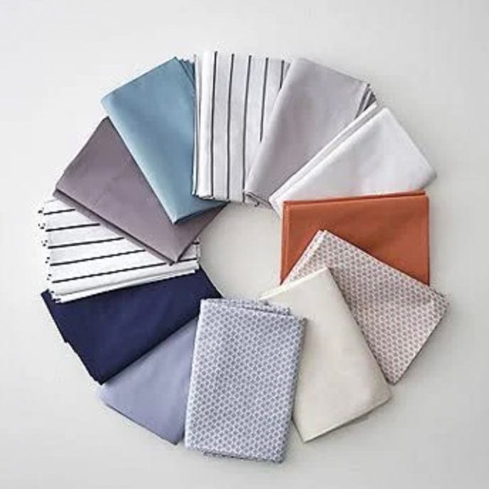 Assorted bed sheets in various colors and patterns, arranged in a circular pattern.