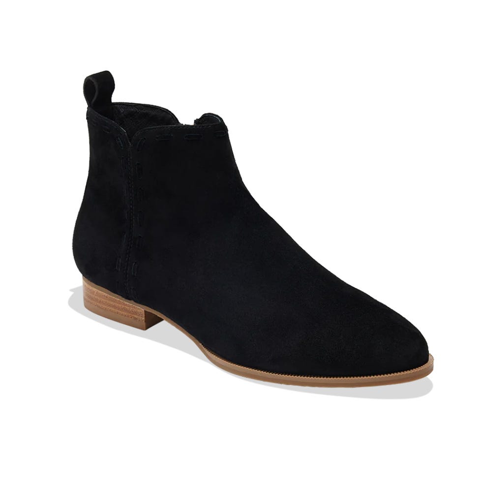 Black suede ankle boots with a low wooden heel, featuring a pull tab at the back for easy wear. The design is sleek and minimalist.