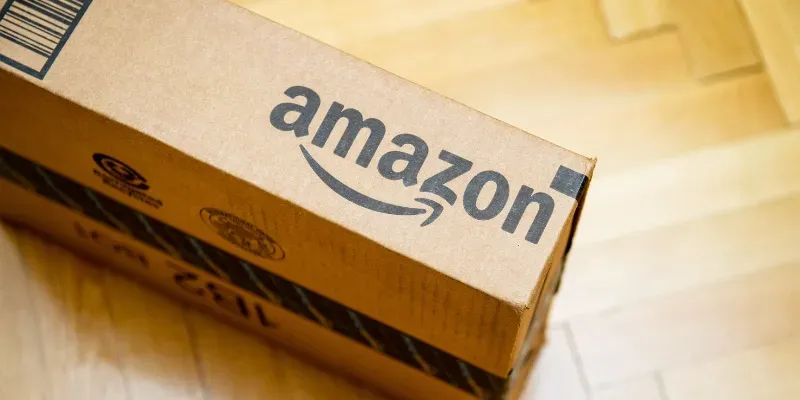 an Amazon cardboard box on a wooden floor