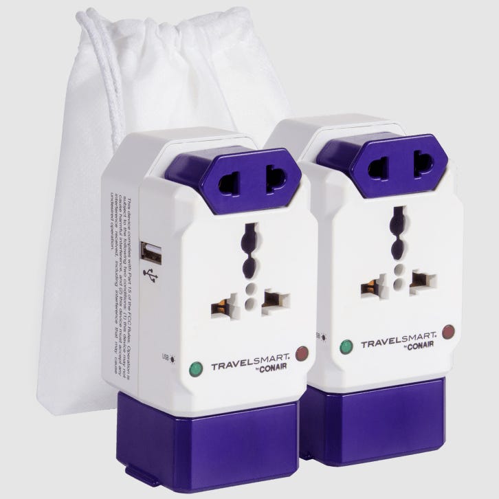 Two white and purple TravelSmart by Conair universal power adapters with carrying pouches.