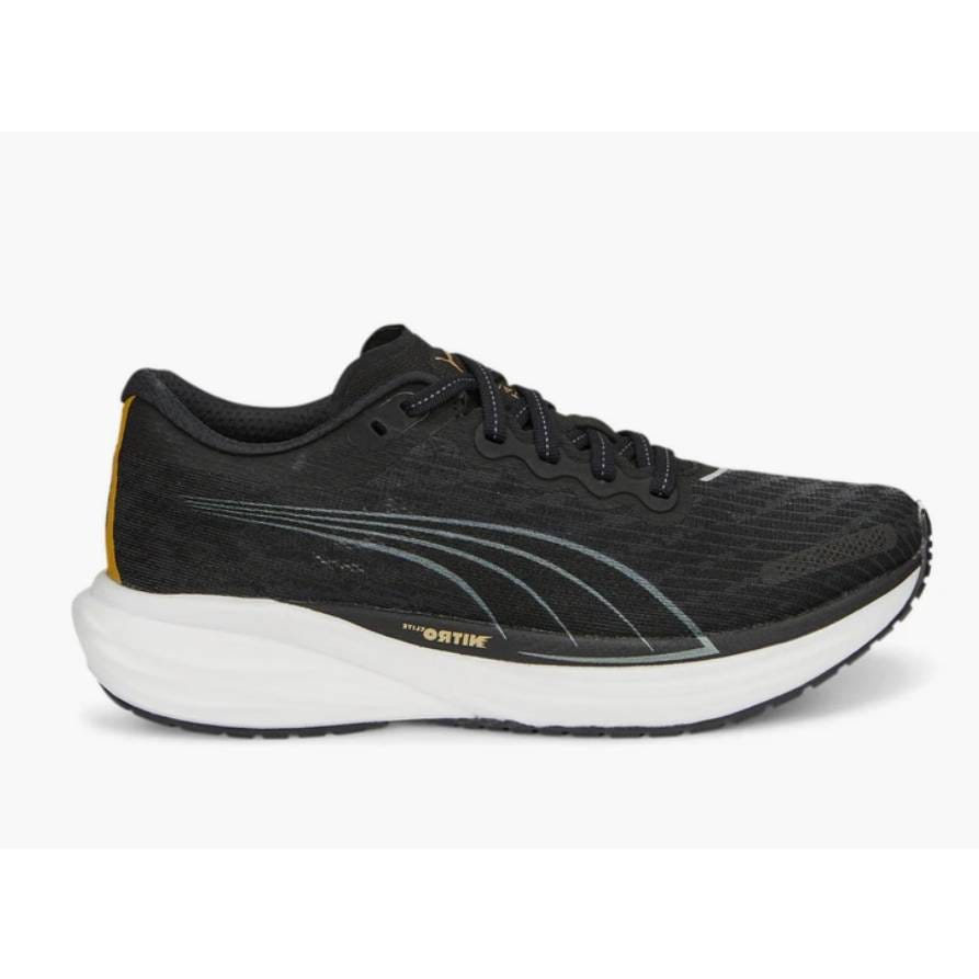 Black running shoe with white sole and subtle gold accents, featuring a lace-up design and branded side stripes.