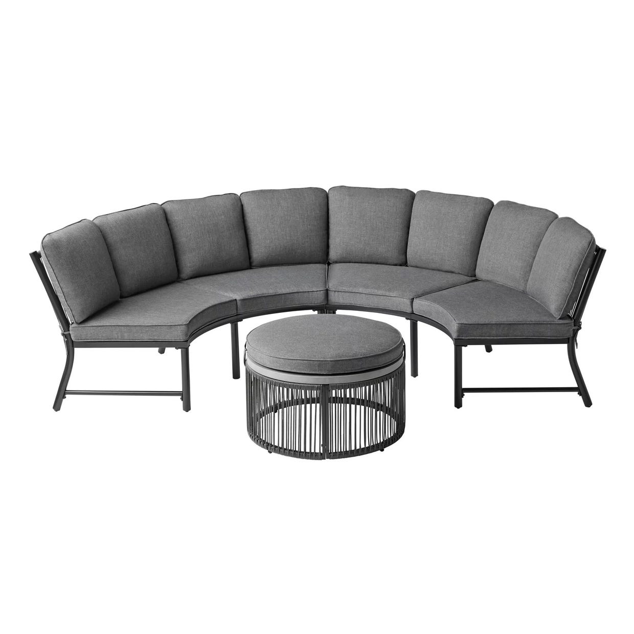 A curved outdoor sectional sofa with cushions and a round coffee table with a slatted design.