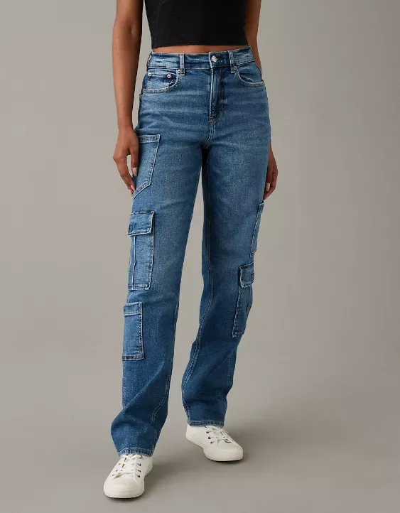 A pair of light blue denim cargo jeans with multiple pockets and a black crop top, complemented by white sneakers.