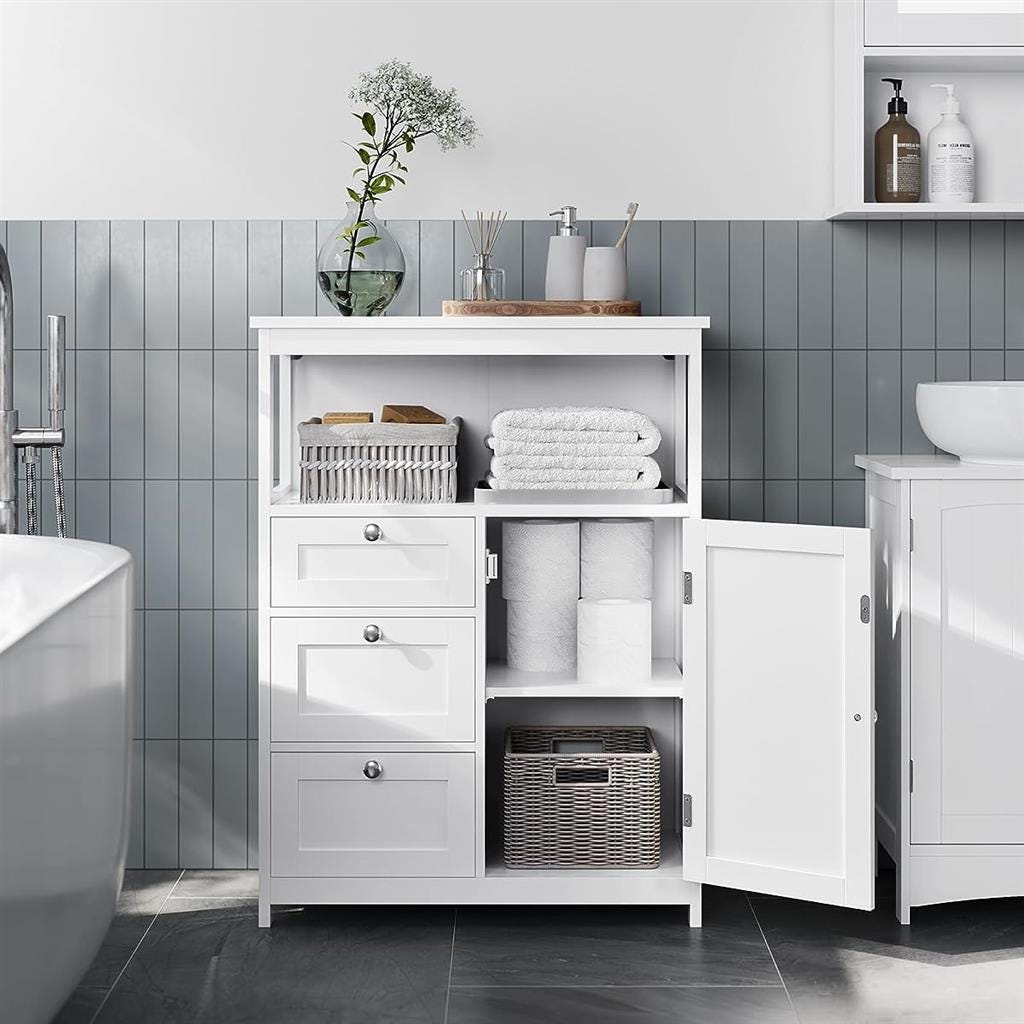 White bathroom storage furniture with shelves, cabinets, and drawers, displaying towels, toiletries, and decorative items.
