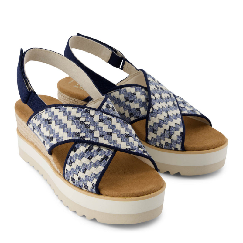 Blue and white woven platform sandals with crisscross straps and a slingback design, featuring a textured sole and a cushioned tan footbed.