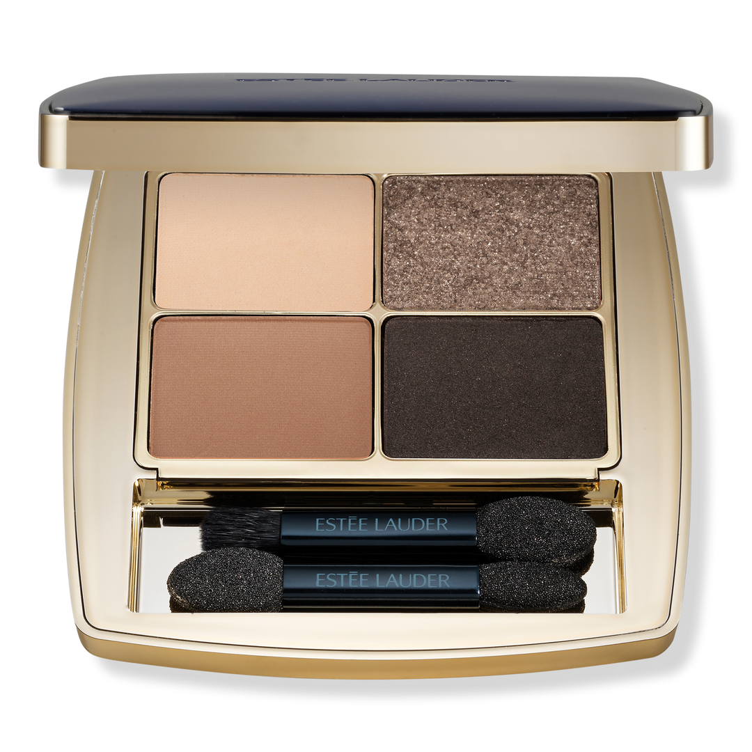 Estée Lauder Eye Shadow Quad features four shades: light beige, shimmery taupe, warm brown, and deep black. It includes two dual-ended applicators and comes in a sleek, gold-toned compact.