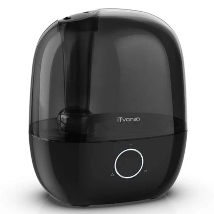 A black iTvanila cool mist humidifier with a sleek, rounded design, featuring a simple control dial in the front.