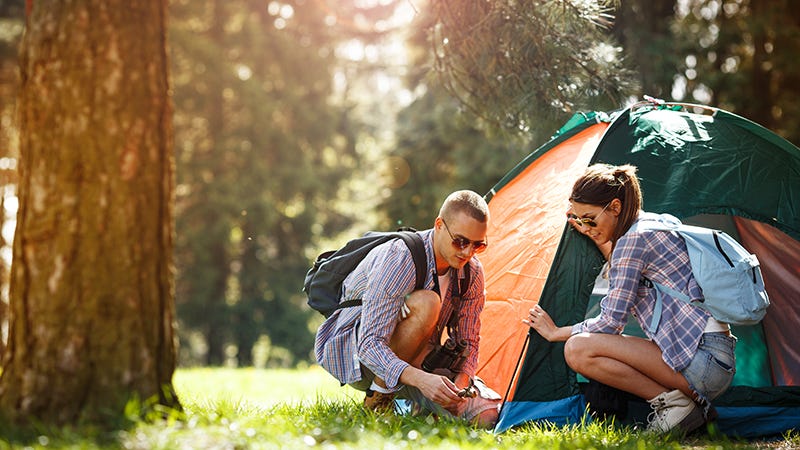 camping couple setting up tent