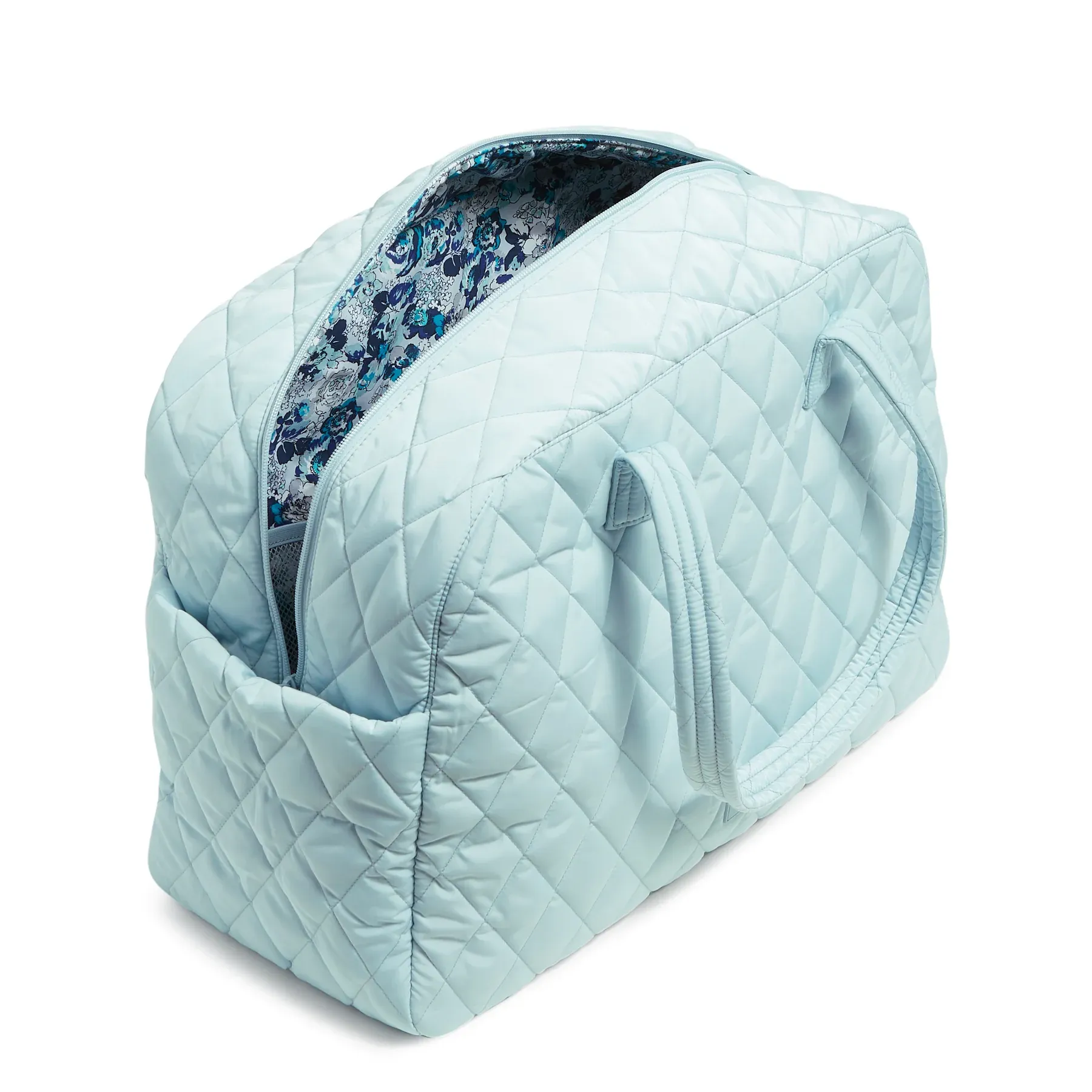 A pale blue quilted duffle bag with a floral pattern interior.