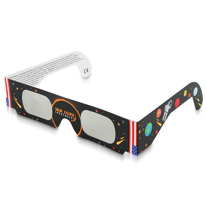 A pair of paper solar eclipse glasses with a space-themed design.