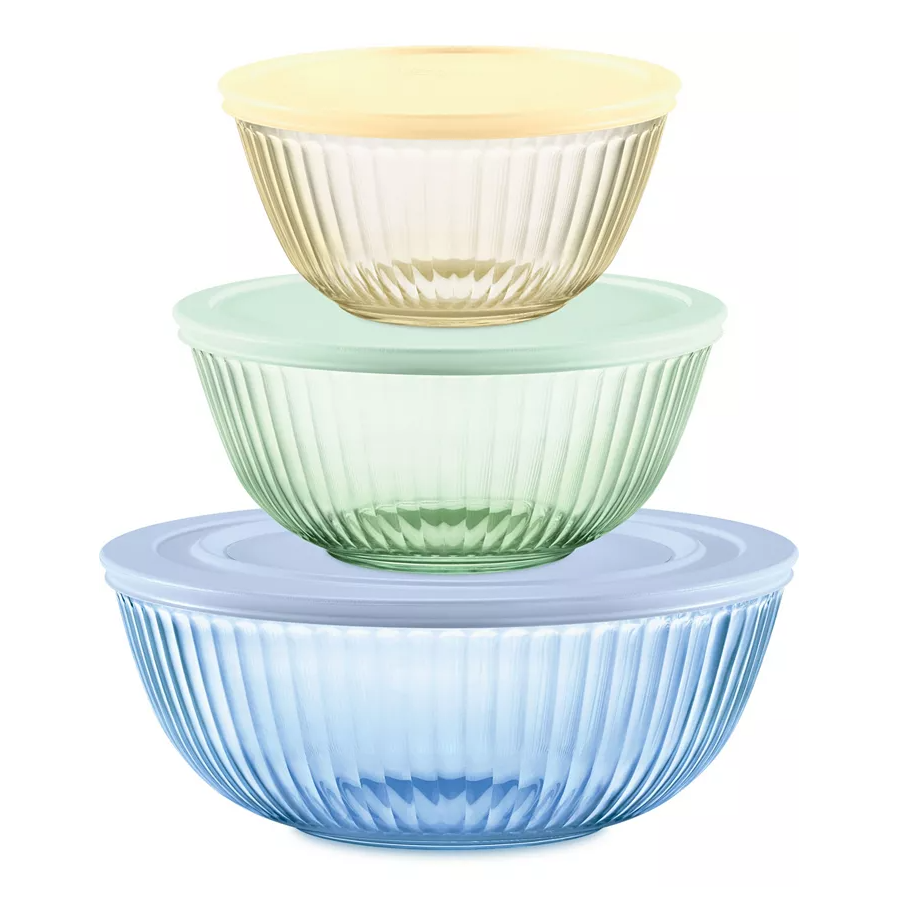 Three nested mixing bowls with lids in blue, green, and cream colors, all with ribbed designs.