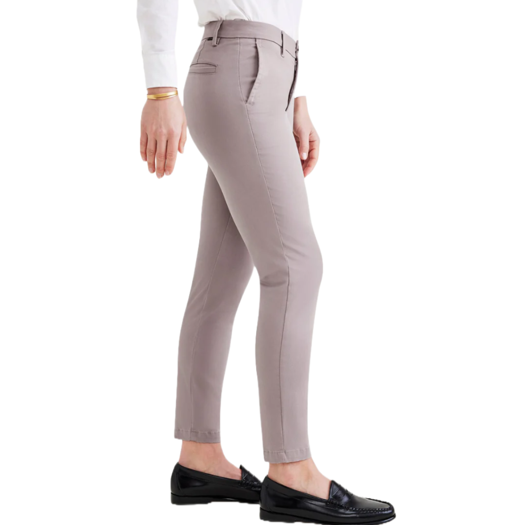 Dockers Weekend Chinos for women are slim-fit pants in a light taupe color, featuring a mid-rise waist, belt loops, and a zip closure. They pair well with dress shoes or casual loafers for versatile styling.
