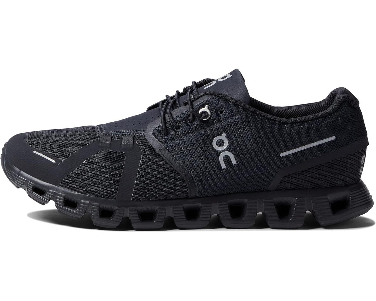 A single black running shoe with distinctive hollowed-out soles.