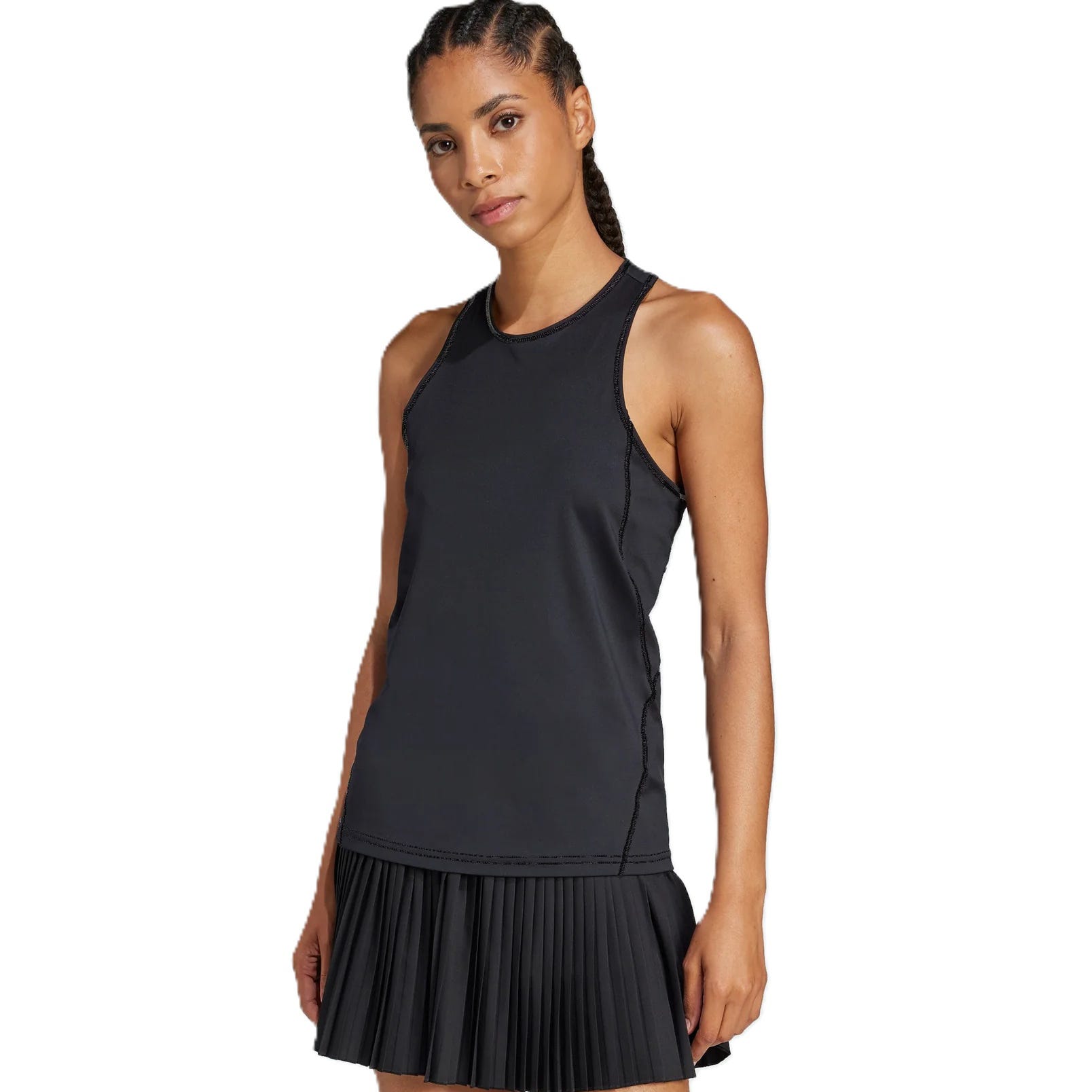 A woman is wearing a black sleeveless athletic dress with a fitted top and pleated skirt.