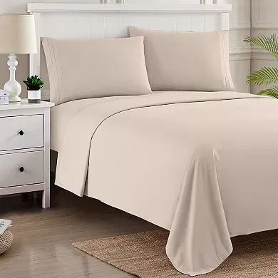 Beige bedding set on a bed, comprising sheets and pillowcases.