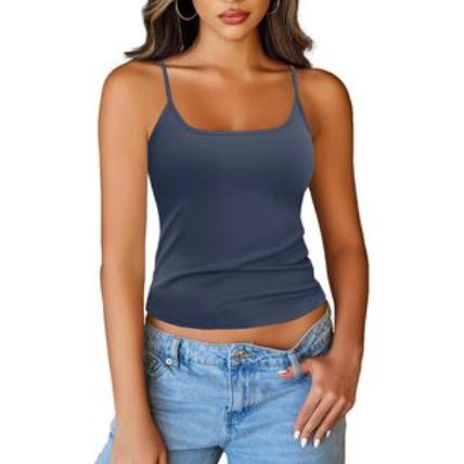 A woman is wearing a dark blue spaghetti strap camisole and light blue jeans. She has long hair and hoop earrings.