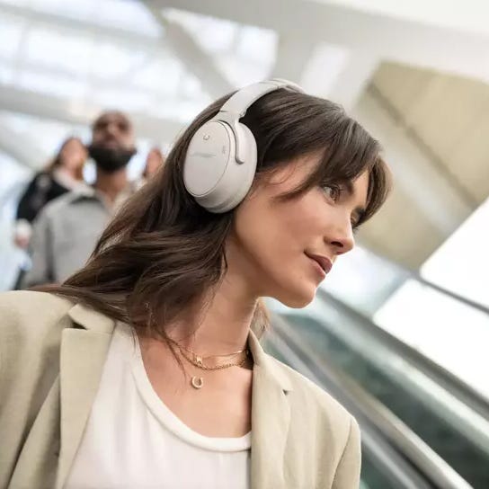 A woman wearing over-ear headphones.