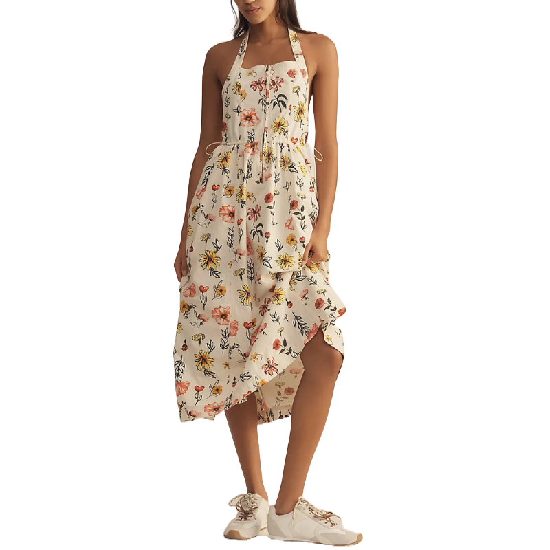 A floral halter-neck midi dress with a high-low hemline, paired with white sneakers.