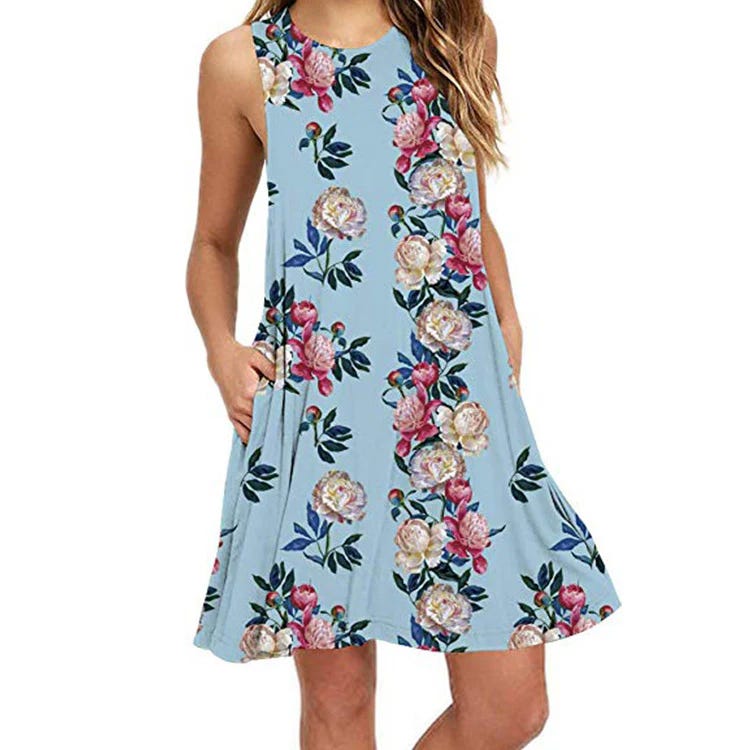 Sleeveless, A-line dress featuring a blue background with a floral pattern of pink and cream flowers, and pockets.