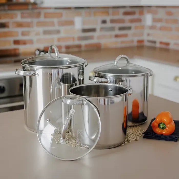 Three stainless steel cooking pots with lids, displayed on a kitchen counter.