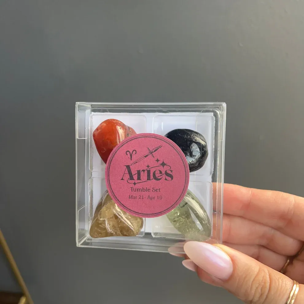 Aries Tumble Set featuring four polished stones in a plastic case, labeled for those born between March 21 and April 19.