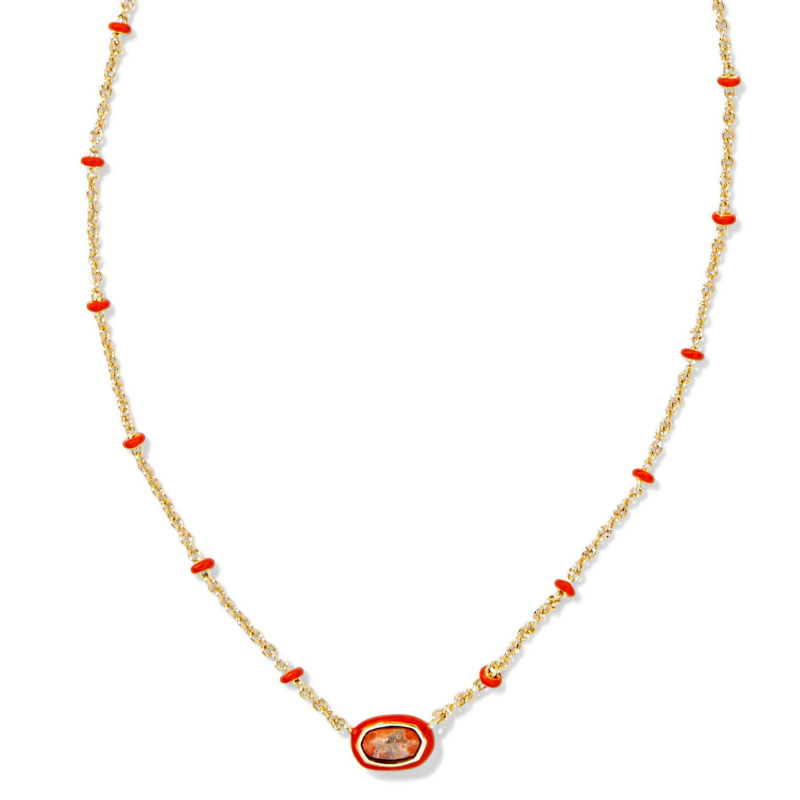 A delicate gold chain necklace featuring small red accents and a central stone encircled in red, creating a subtle yet striking design.
