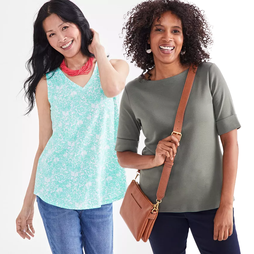 Two women modeling casual clothing: one in a teal patterned sleeveless top and red necklace, the other in an olive green elbow-sleeve top with a shoulder bag.