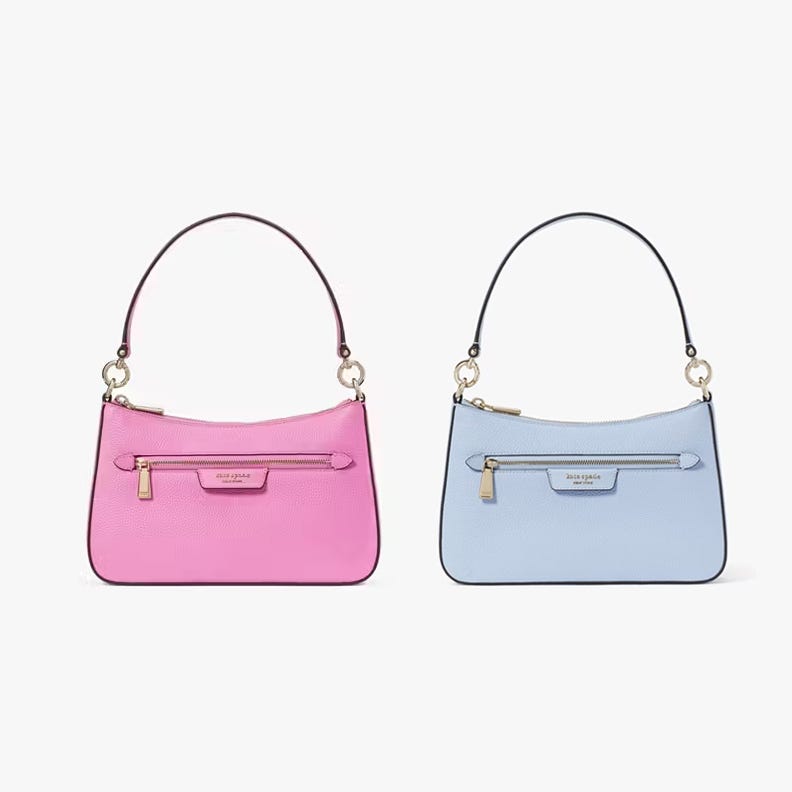Two handbags in pink and blue with front zippers and brand tags.