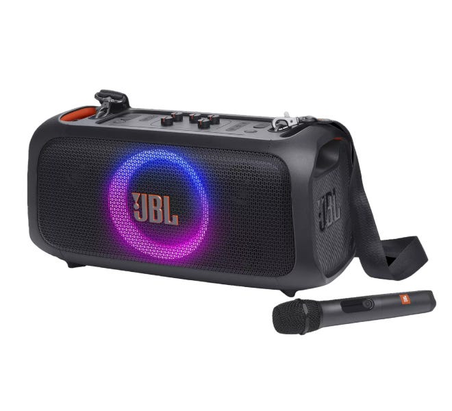 JBL portable party speaker with a carrying strap, featuring LED lights on the front grill and accompanying microphone.