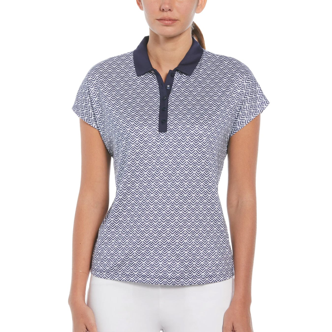 A woman wearing a patterned short-sleeve golf polo shirt with a navy collar.
