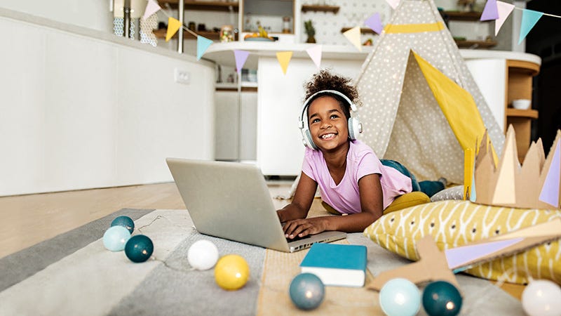 girl using laptop wearing headhones