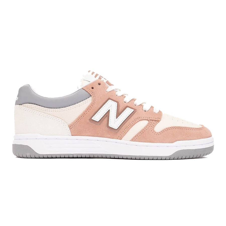 New Balance low-top sneaker featuring a beige, pink, and gray color scheme with a white \“N\“ logo on the side.