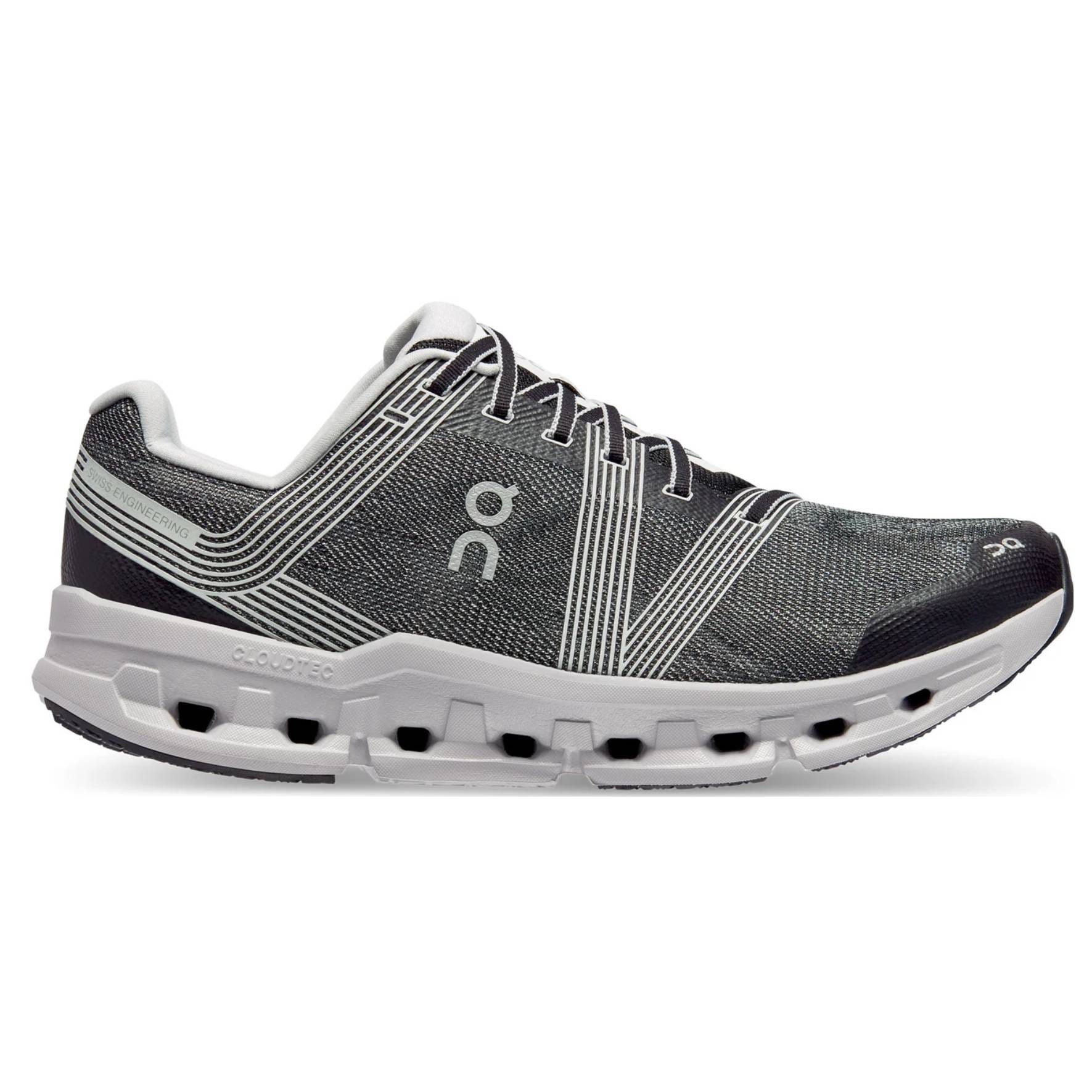 A pair of black and white On CloudTec running shoes with distinctive sole design.