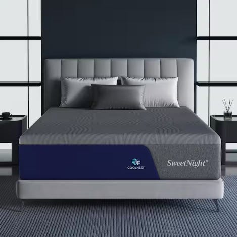 A bed with a gray and blue SweetNight mattress featuring \“COOLNEST\“ technology, accompanied by gray pillows and resting on a textured floor.